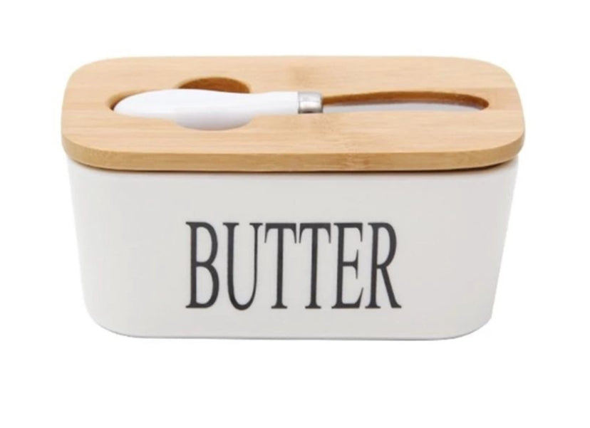 Butter container with wooden lid and white handle on a white background